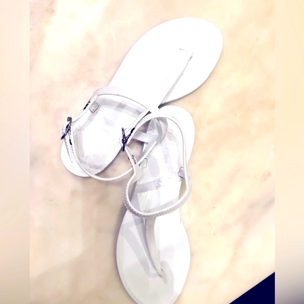 New Stuart Weitzman white patent t-strapped sandals.